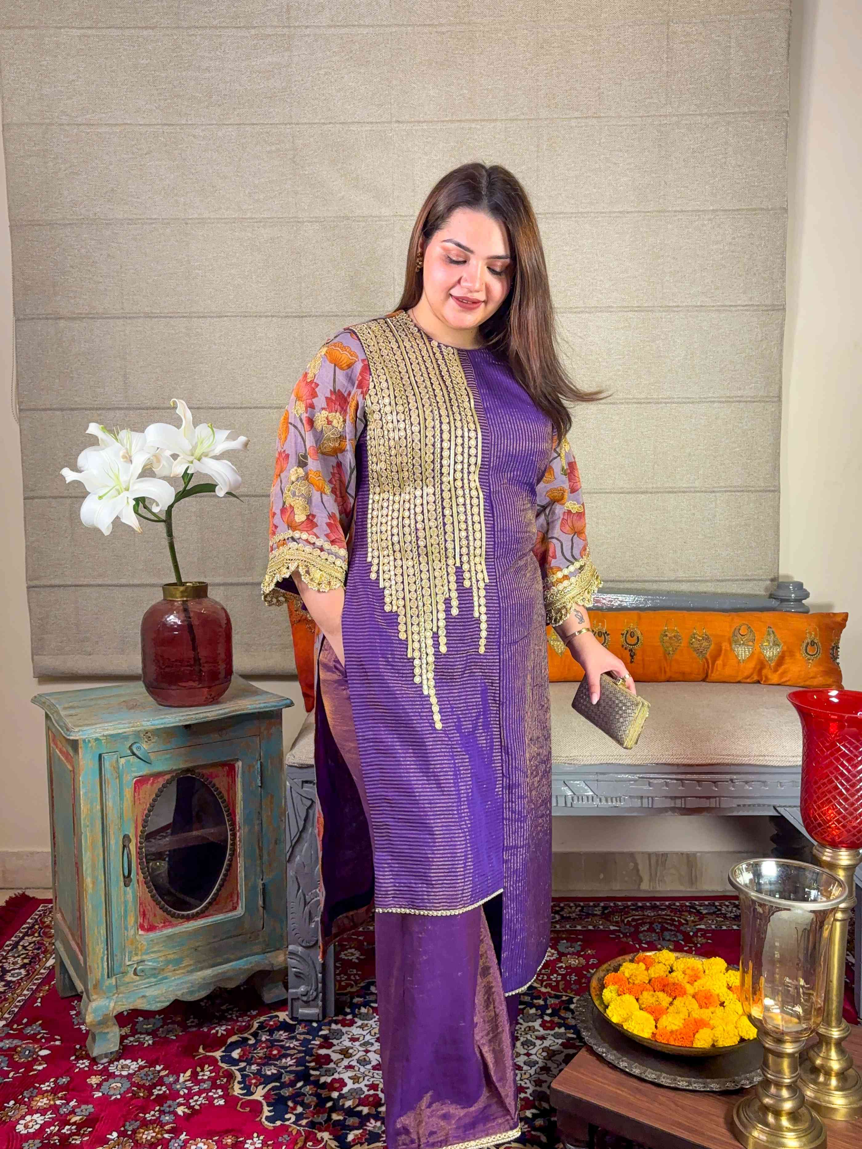 A model showcasing Purple Asymmetrical Kurta Palazzo Set by Miithhii Elaychii from Miithhii Elaychii's collection