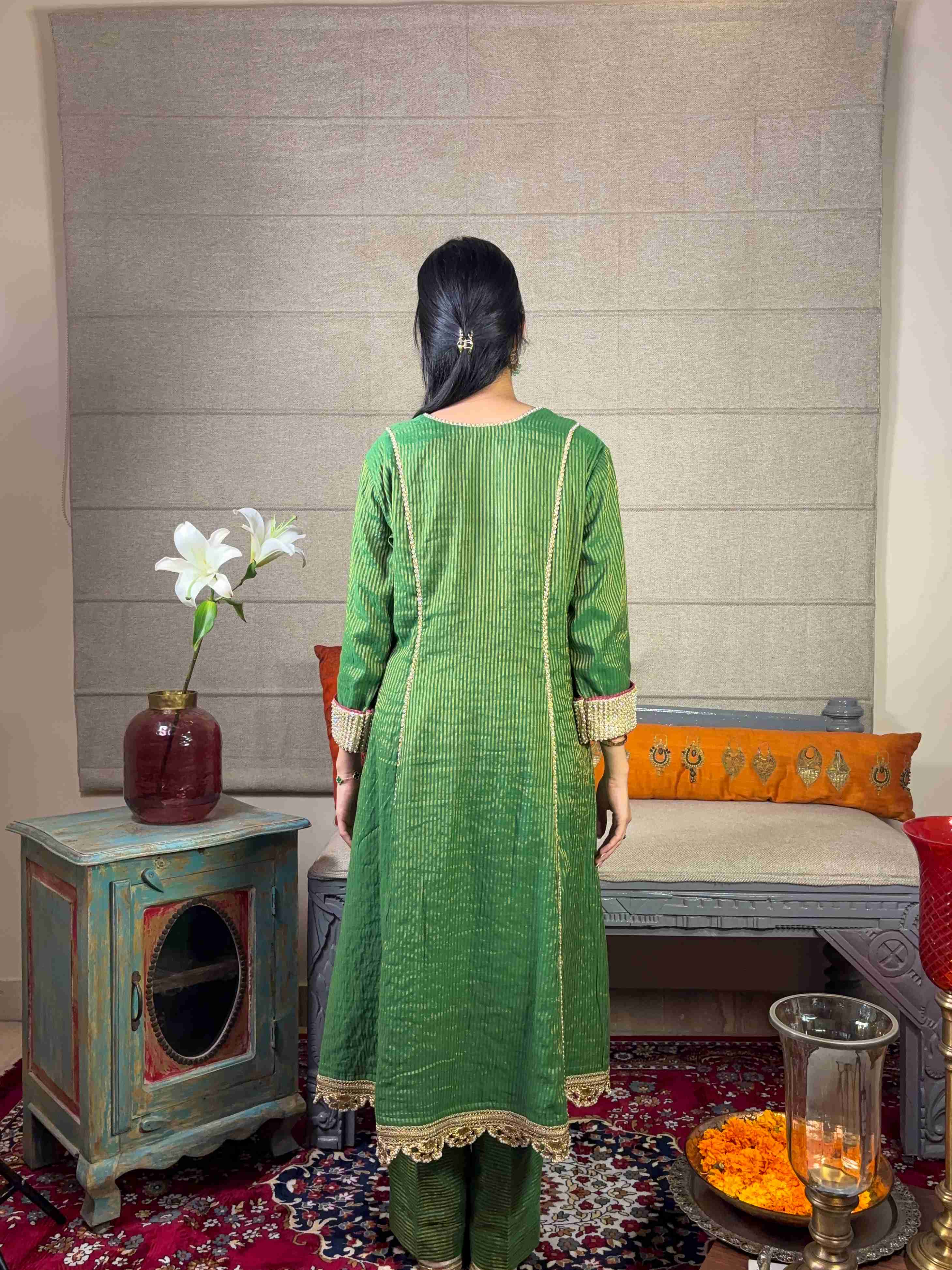 A model showcasing Banarsi Green Kurta With Straight Pants Set by Miithhii Elaychii from Miithhii Elaychii's collection