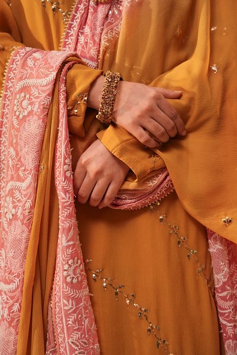 A model showcasing Mustard Mukaish Kurta With Shaded Dupatta by Myra By Anju Narian from Myra By Anju Narian's collection A model showcasing Mustard Mukaish Kurta With Shaded Dupatta by Myra By Anju Narian from Myra By Anju Narian's collection