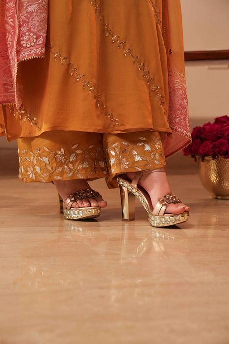 A model showcasing Mustard Mukaish Kurta With Shaded Dupatta by Myra By Anju Narian from Myra By Anju Narian's collection A model showcasing Mustard Mukaish Kurta With Shaded Dupatta by Myra By Anju Narian from Myra By Anju Narian's collection