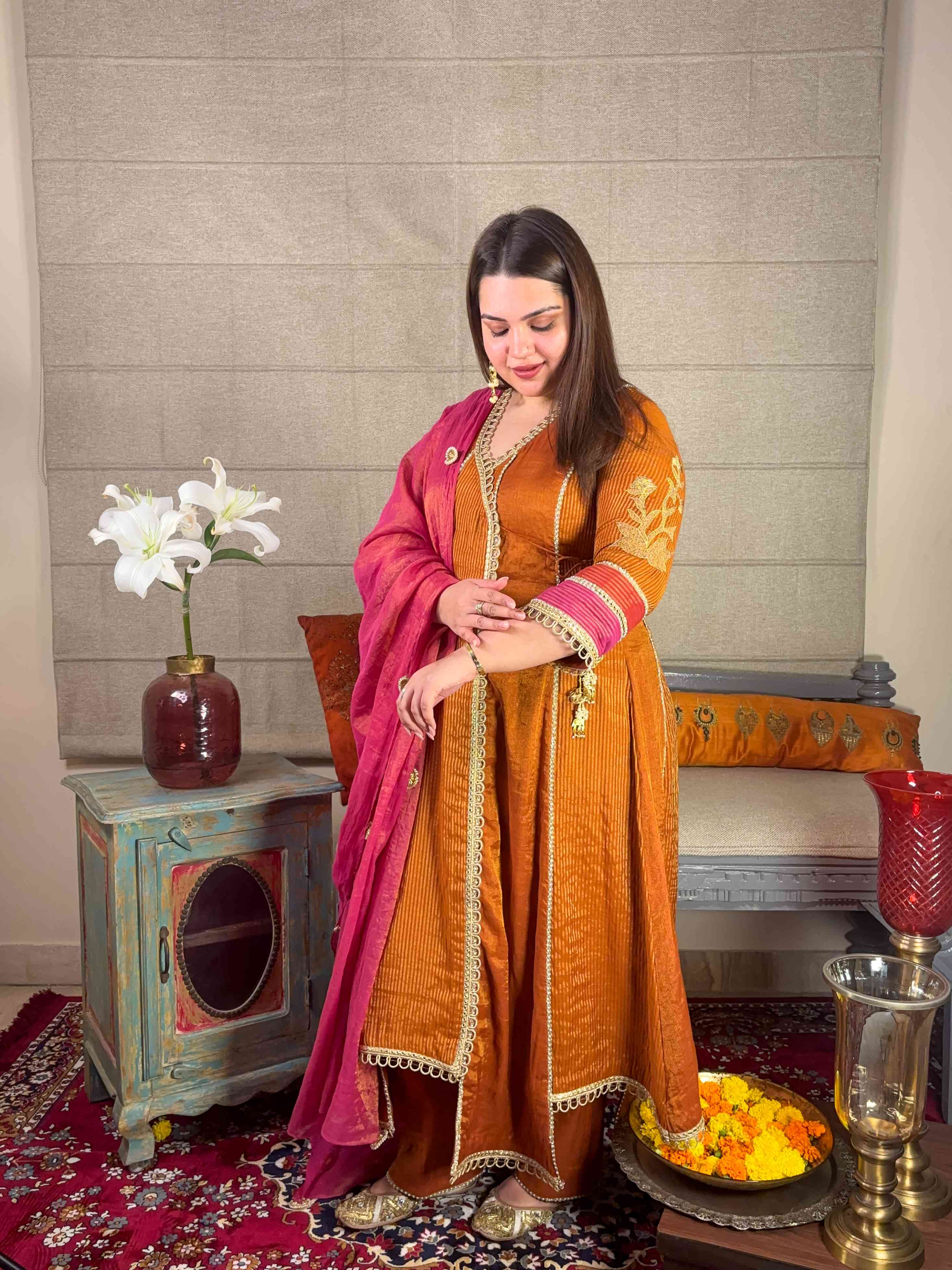 A model showcasing Mustard Banarsi Highlow Angrakha Set by Miithhii Elaychii from Miithhii Elaychii's collection