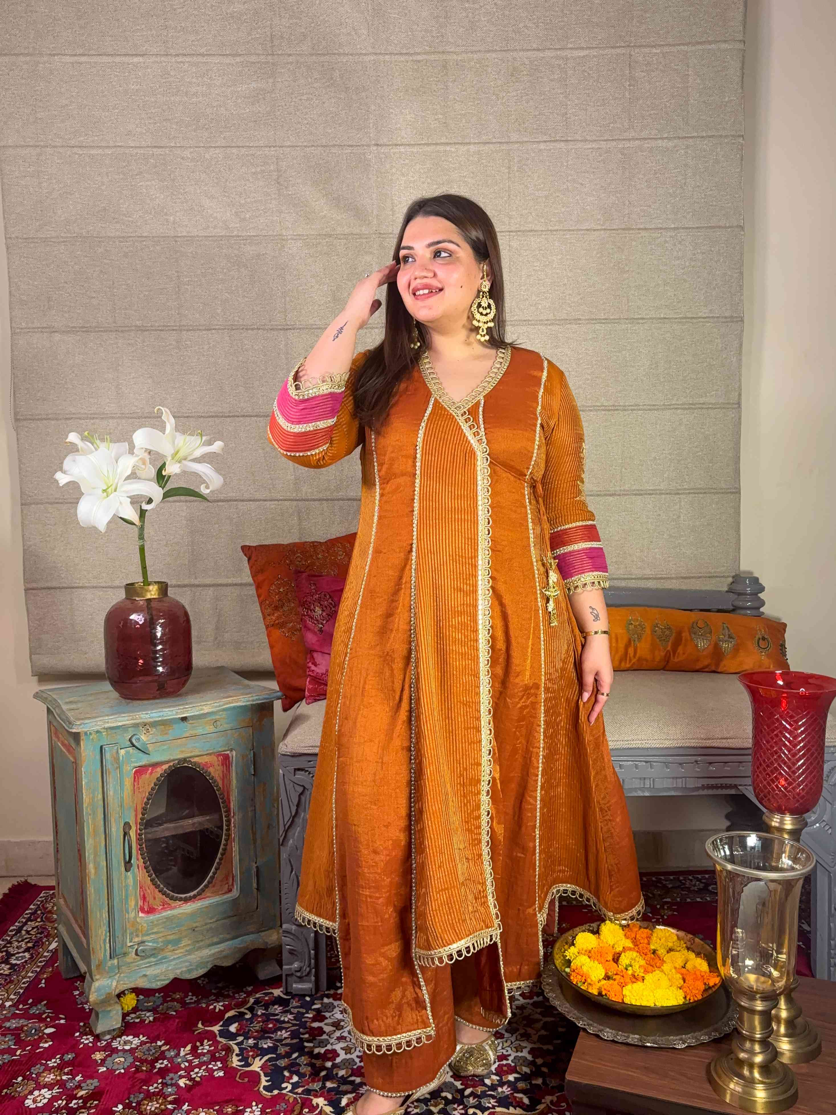 A model showcasing Mustard Banarsi Highlow Angrakha Set by Miithhii Elaychii from Miithhii Elaychii's collection