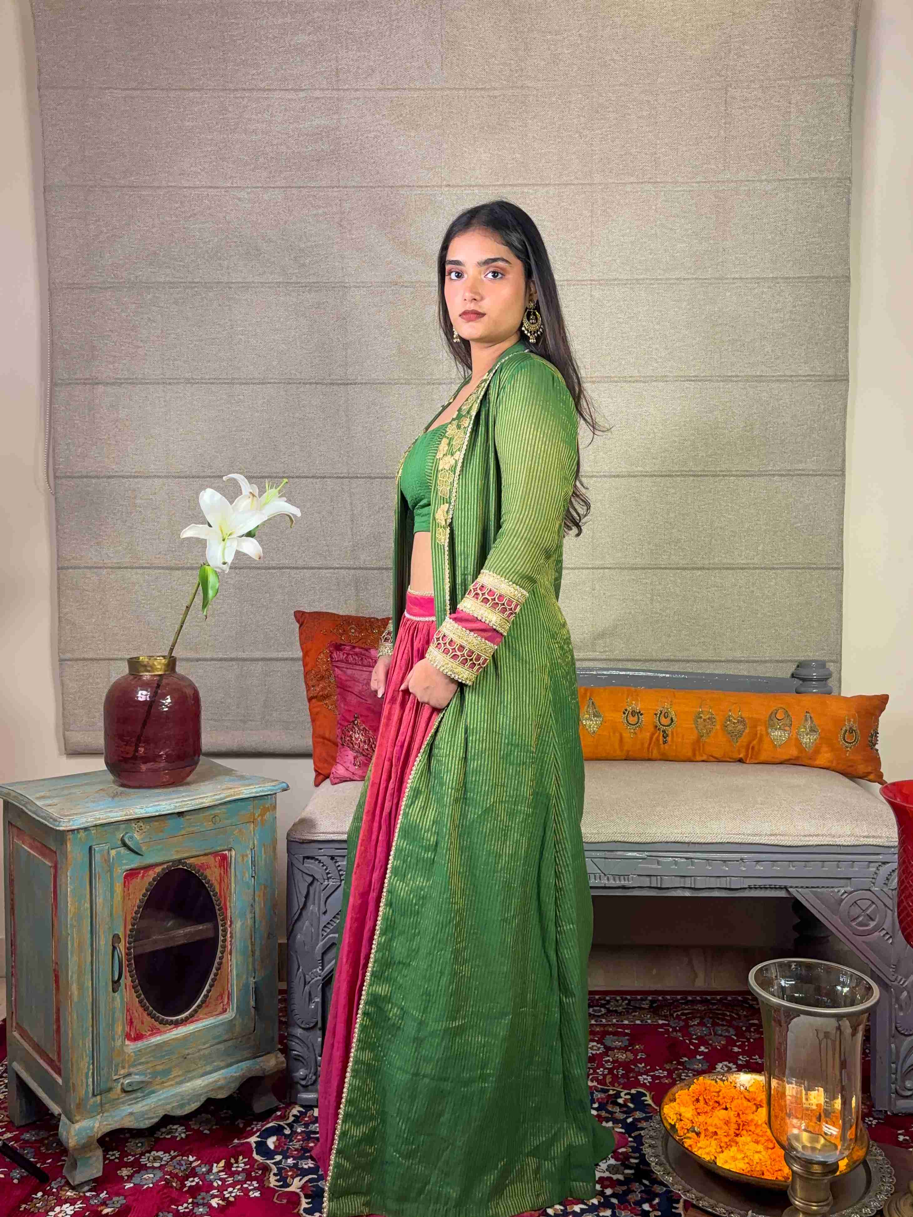 A model showcasing Banarsi Long Green Cape With Skirt Set by Miithhii Elaychii from Miithhii Elaychii's collection