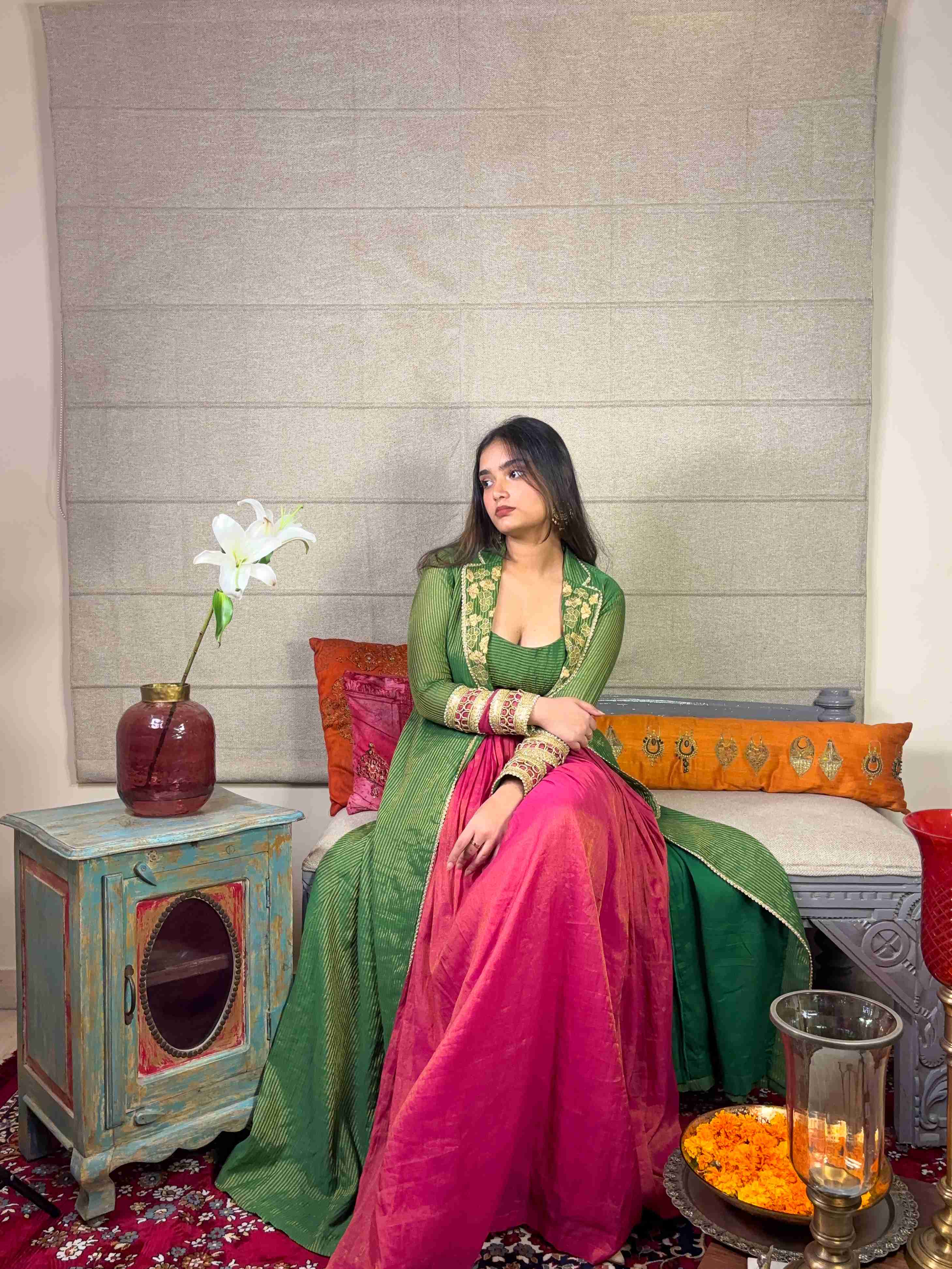 A model showcasing Banarsi Long Green Cape With Skirt Set by Miithhii Elaychii from Miithhii Elaychii's collection