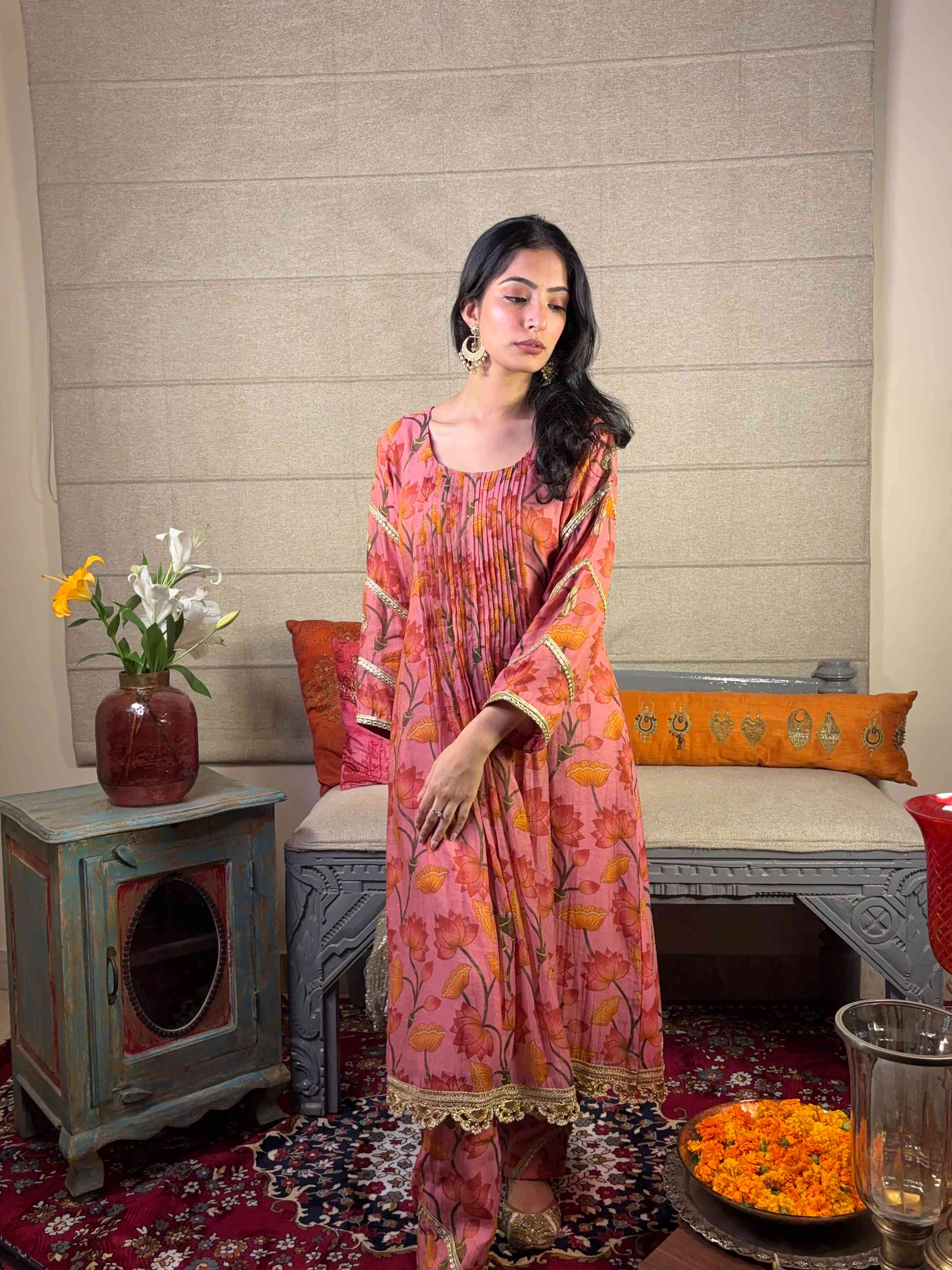 A model showcasing Pink Floral Kurta Pants Set by Miithhii Elaychii from Miithhii Elaychii's collection