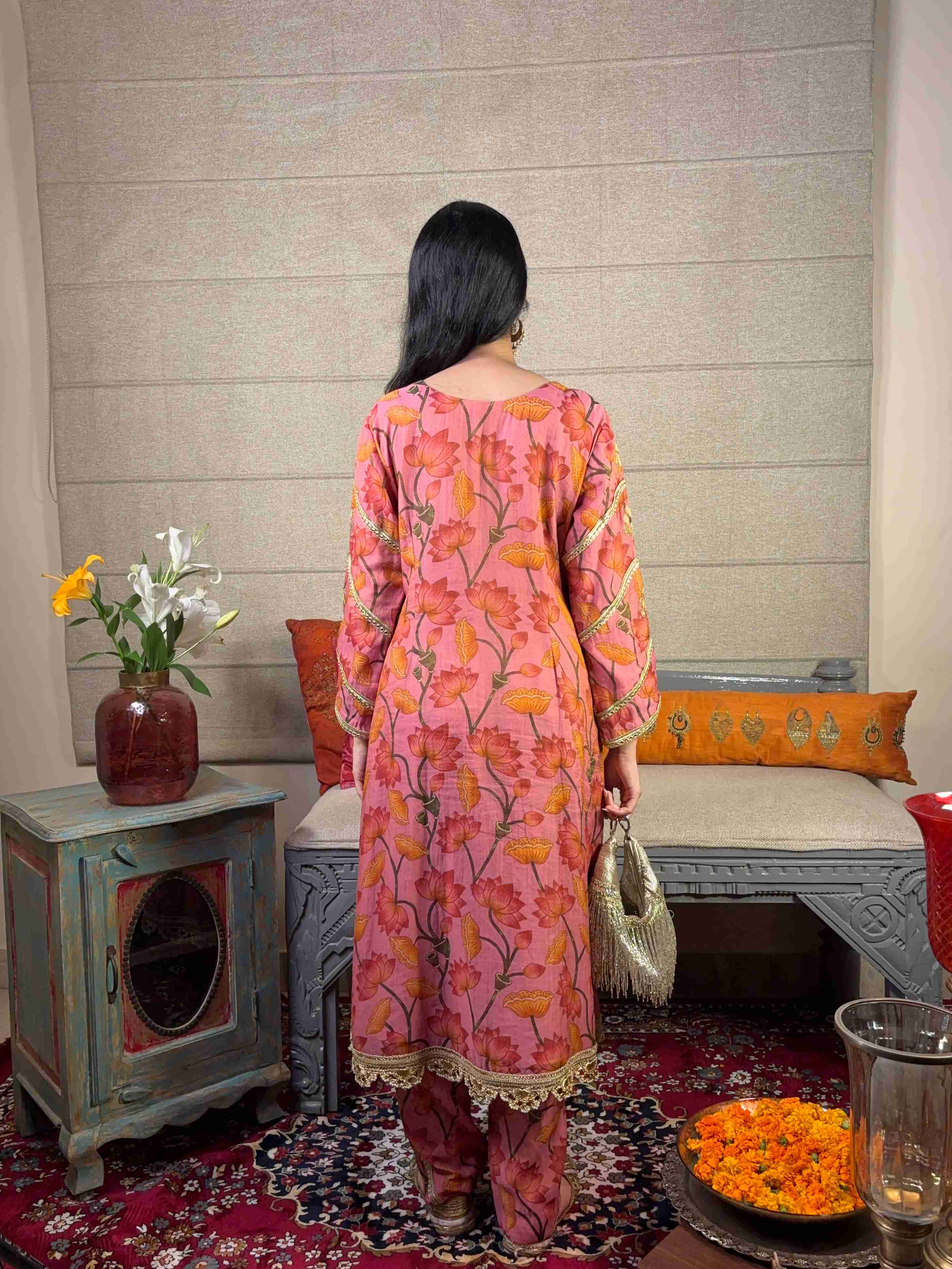 A model showcasing Pink Floral Kurta Pants Set by Miithhii Elaychii from Miithhii Elaychii's collection