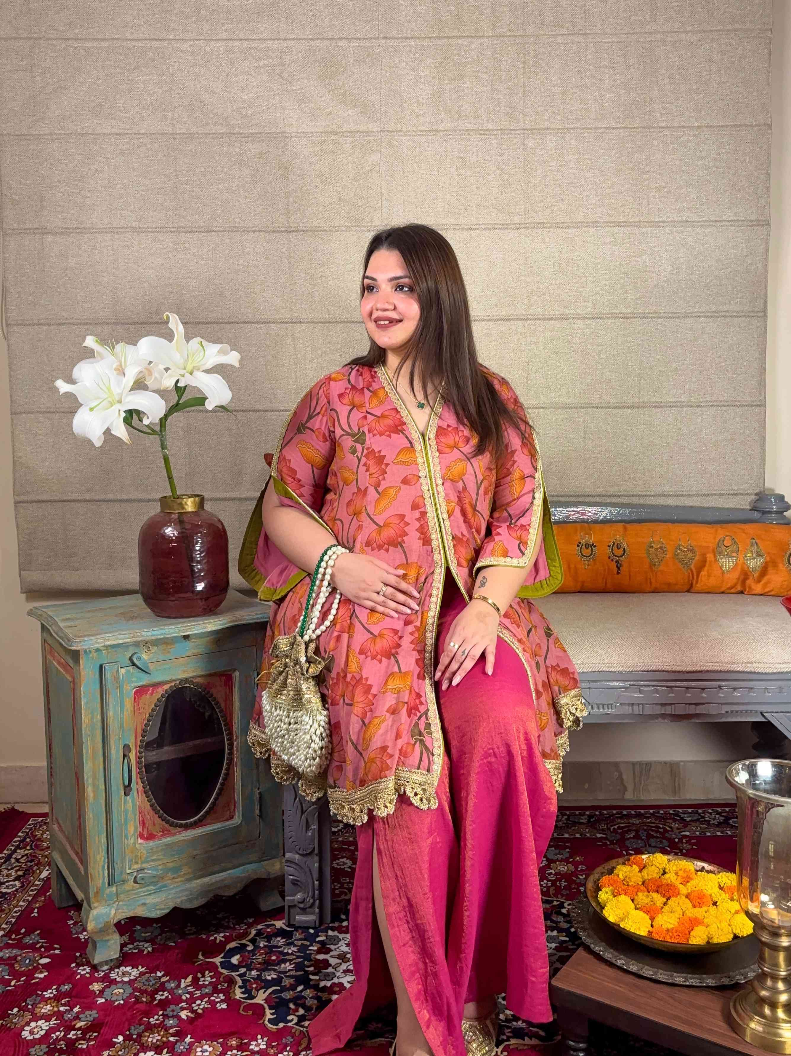 A model showcasing Pink Floral Short Kurta With Pants Set by Miithhii Elaychii from Miithhii Elaychii's collection
