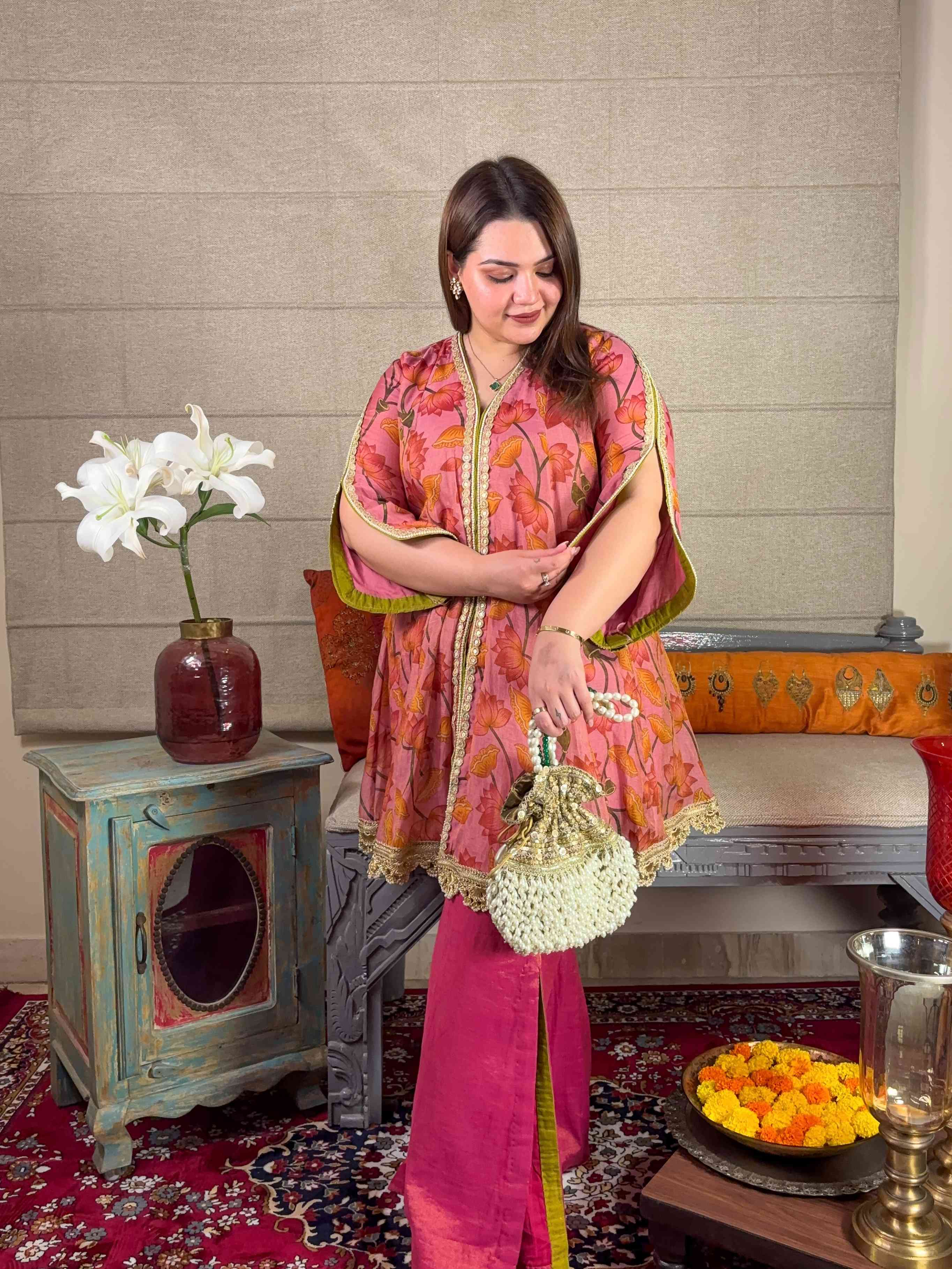 A model showcasing Pink Floral Short Kurta With Pants Set by Miithhii Elaychii from Miithhii Elaychii's collection