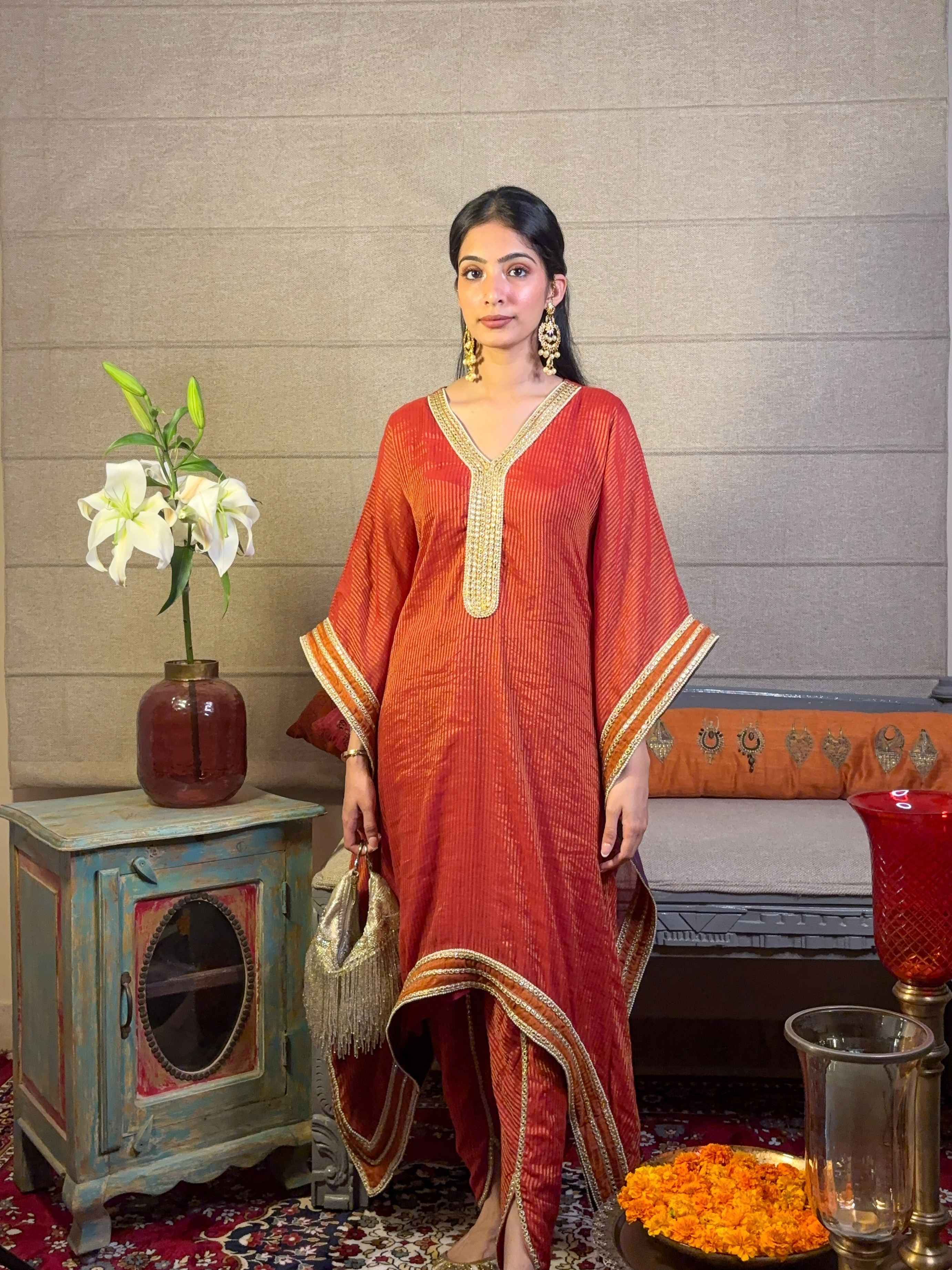 A model showcasing Burnt Orange Kaftan With Tulip Pants Set by Miithhii Elaychii from Miithhii Elaychii's collection