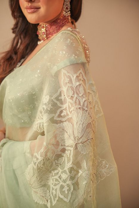 A model showcasing Ice Blue Chikankari Saree With Net Blouse by Myra By Anju Narian from Myra By Anju Narian's collection A model showcasing Ice Blue Chikankari Saree With Net Blouse by Myra By Anju Narian from Myra By Anju Narian's collection
