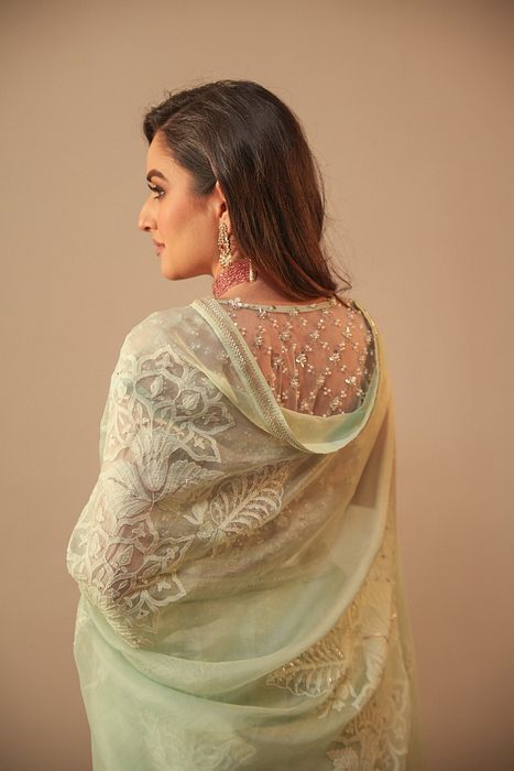 A model showcasing Ice Blue Chikankari Saree With Net Blouse by Myra By Anju Narian from Myra By Anju Narian's collection A model showcasing Ice Blue Chikankari Saree With Net Blouse by Myra By Anju Narian from Myra By Anju Narian's collection