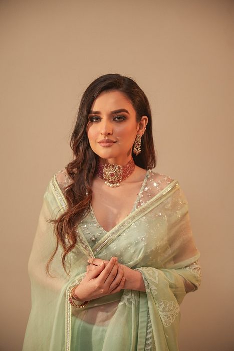 A model showcasing Ice Blue Chikankari Saree With Net Blouse by Myra By Anju Narian from Myra By Anju Narian's collection A model showcasing Ice Blue Chikankari Saree With Net Blouse by Myra By Anju Narian from Myra By Anju Narian's collection