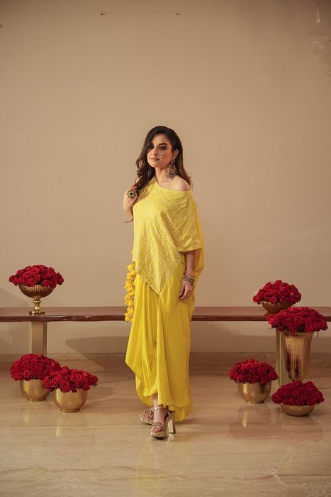 A model showcasing Chikankari Asymmetrical Tunic With Tassels And Dhoti by Myra By Anju Narian from Myra By Anju Narian's collection