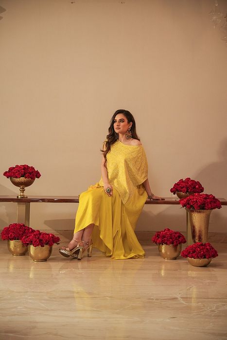 A model showcasing Chikankari Asymmetrical Tunic With Tassels And Dhoti by Myra By Anju Narian from Myra By Anju Narian's collection A model showcasing Chikankari Asymmetrical Tunic With Tassels And Dhoti by Myra By Anju Narian from Myra By Anju Narian's collection