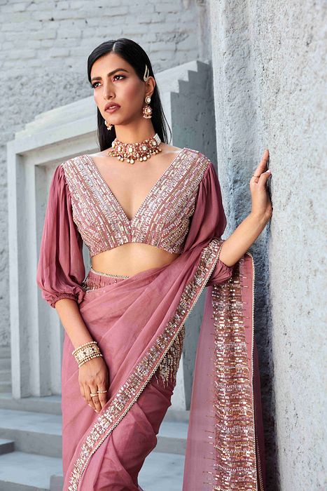 A model showcasing Oraganza Saree With Reglan Puff Sleeve Blouse by Ranian from Ranian's collection A model showcasing Oraganza Saree With Reglan Puff Sleeve Blouse by Ranian from Ranian's collection