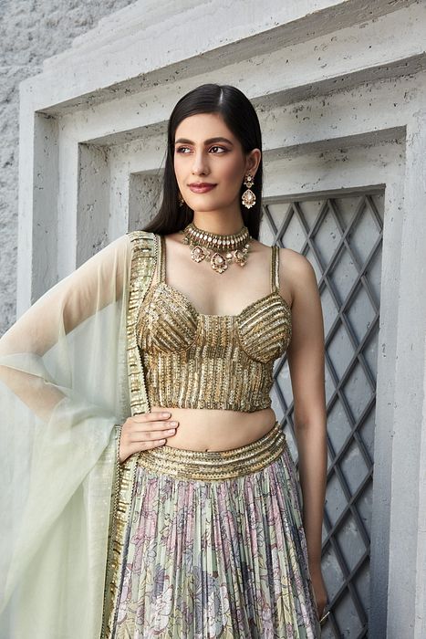 A model showcasing Lilian Print 2 Tier Lengha Corset Set by Ranian from Ranian's collection