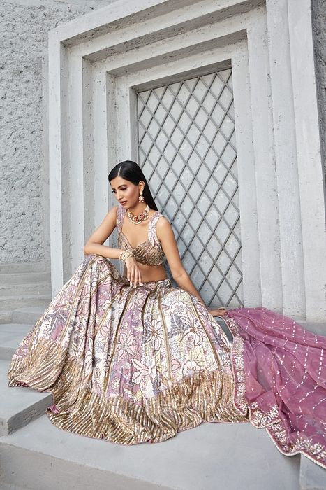 A model showcasing Rose Pink Lilian Print Lengha by Ranian from Ranian's collection A model showcasing Rose Pink Lilian Print Lengha by Ranian from Ranian's collection