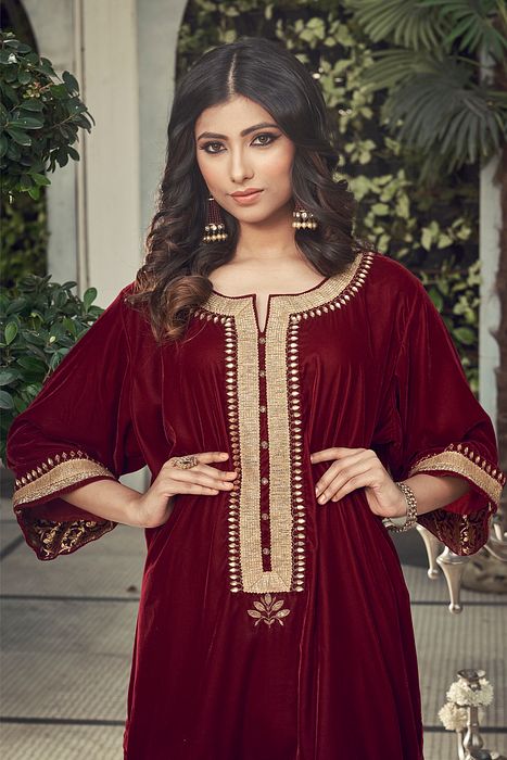 A model showcasing Mahroon Velvet Kurta Set by Ranian from Ranian's collection A model showcasing Mahroon Velvet Kurta Set by Ranian from Ranian's collection