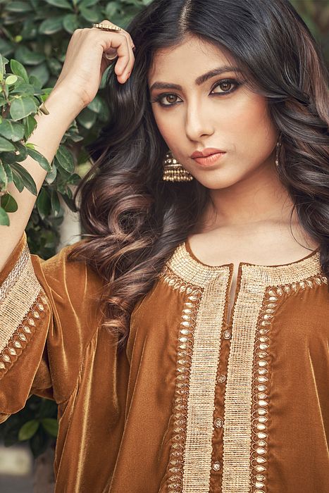 A model showcasing Sand Colour Velvet Kurta Set by Ranian from Ranian's collection A model showcasing Sand Colour Velvet Kurta Set by Ranian from Ranian's collection