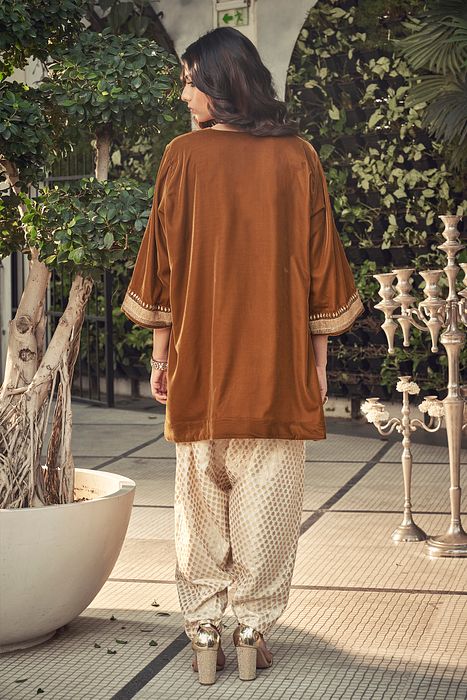 A model showcasing Sand Colour Velvet Kurta Set by Ranian from Ranian's collection A model showcasing Sand Colour Velvet Kurta Set by Ranian from Ranian's collection