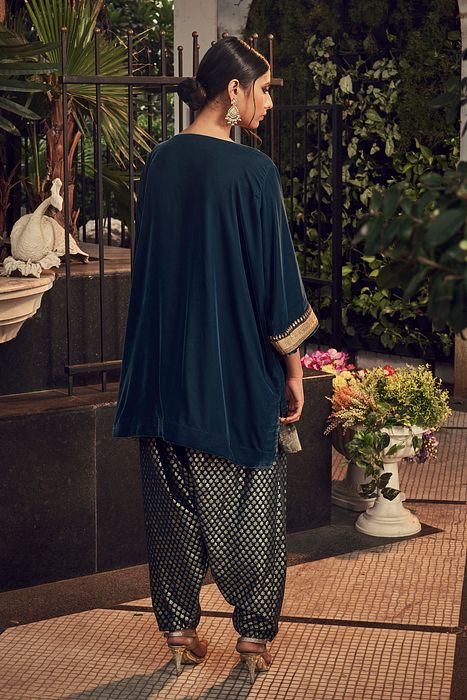 A model showcasing Prussian Blue Velvet Kurta Set by Ranian from Ranian's collection A model showcasing Prussian Blue Velvet Kurta Set by Ranian from Ranian's collection