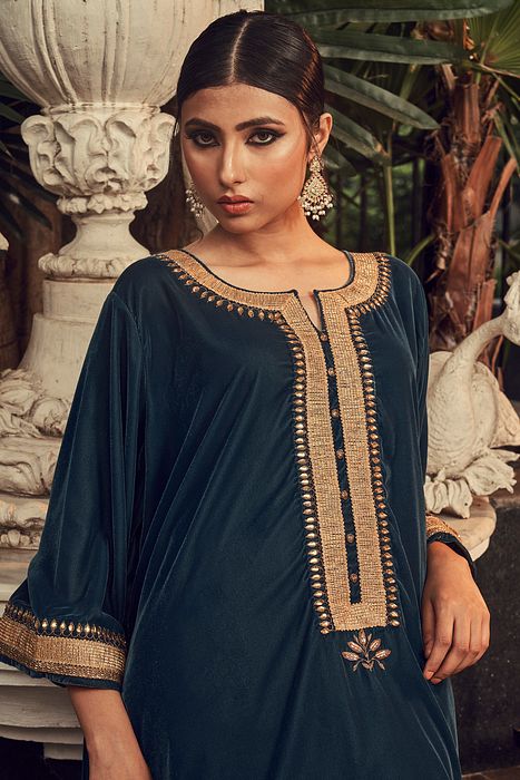 A model showcasing Prussian Blue Velvet Kurta Set by Ranian from Ranian's collection A model showcasing Prussian Blue Velvet Kurta Set by Ranian from Ranian's collection