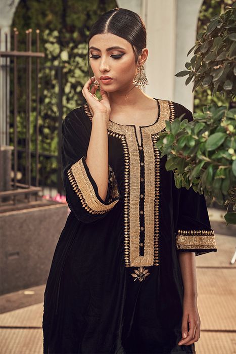 A model showcasing Black Velvet Kurta Set by Ranian from Ranian's collection A model showcasing Black Velvet Kurta Set by Ranian from Ranian's collection