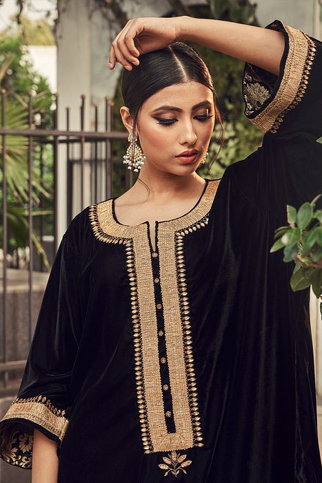 A model showcasing Black Velvet Kurta Set by Ranian from Ranian's collection A model showcasing Black Velvet Kurta Set by Ranian from Ranian's collection