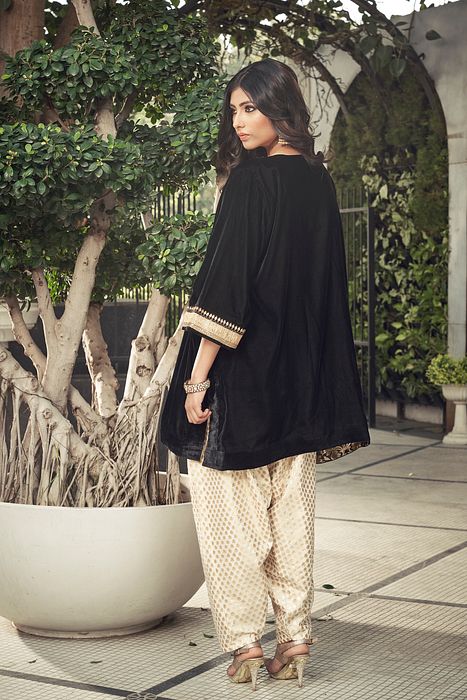 A model showcasing Black Velvet Kurta With Dhoti Salwar by Ranian from Ranian's collection A model showcasing Black Velvet Kurta With Dhoti Salwar by Ranian from Ranian's collection