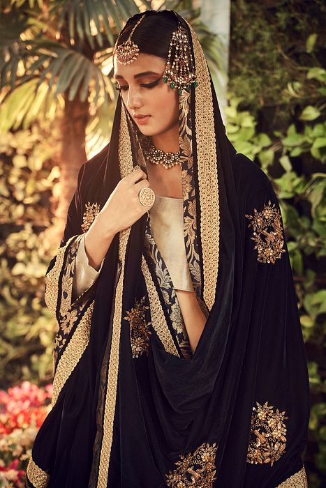 A model showcasing Champagne Lehenga Set by Ranian from Ranian's collection A model showcasing Champagne Lehenga Set by Ranian from Ranian's collection