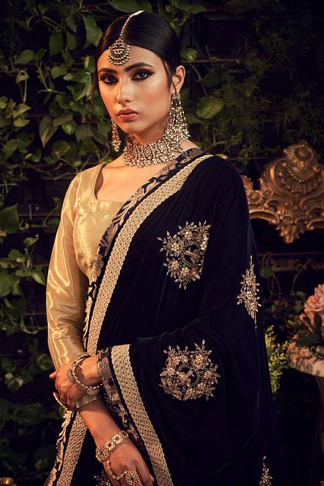 A model showcasing Oxidised Gold Lengha Set With Velvet Dupatta Shawl by Ranian from Ranian's collection A model showcasing Oxidised Gold Lengha Set With Velvet Dupatta Shawl by Ranian from Ranian's collection