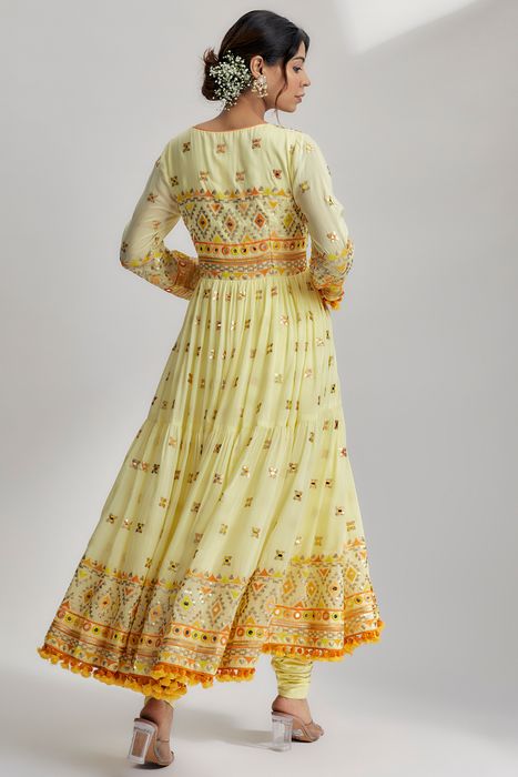 A model showcasing Riana Tiered Ag With Churidar In Yellow by Gopi Vaid from Gopi Vaid's collection