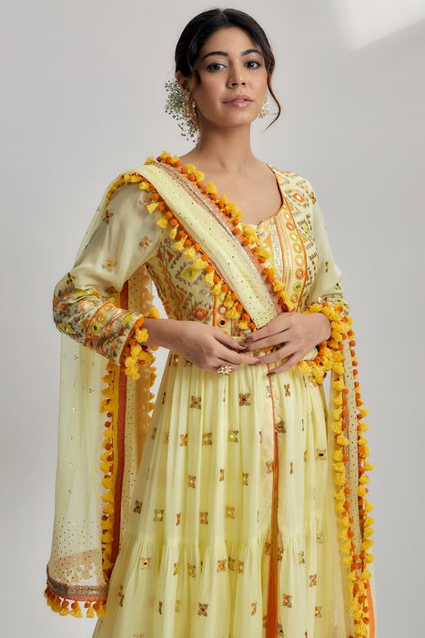 A model showcasing Riana Tiered Ag With Churidar In Yellow by Gopi Vaid from Gopi Vaid's collection