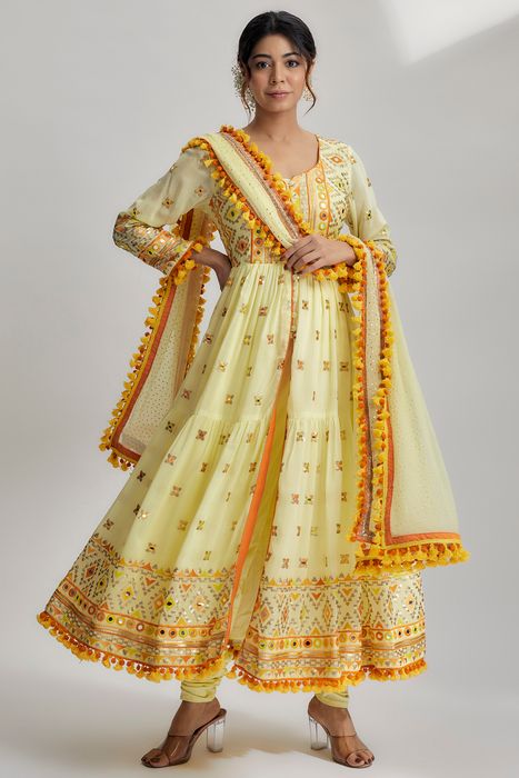 A model showcasing Riana Tiered Ag With Churidar In Yellow by Gopi Vaid from Gopi Vaid's collection