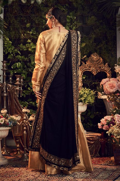 A model showcasing Oxidised Gold Garara Set With Velvet Dupatta Shawl by Ranian from Ranian's collection A model showcasing Oxidised Gold Garara Set With Velvet Dupatta Shawl by Ranian from Ranian's collection