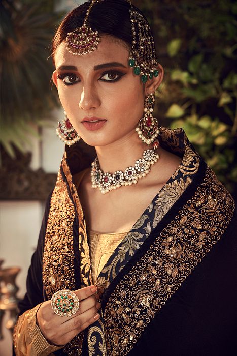 A model showcasing Oxidised Gold Garara Set With Velvet Dupatta Shawl by Ranian from Ranian's collection A model showcasing Oxidised Gold Garara Set With Velvet Dupatta Shawl by Ranian from Ranian's collection