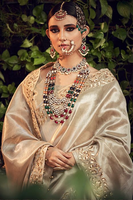 A model showcasing Champagne Lengha Set With Dupatta by Ranian from Ranian's collection