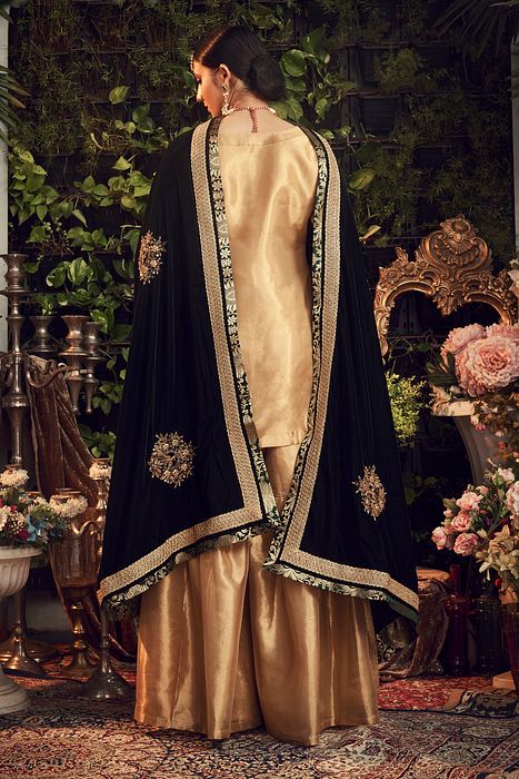 A model showcasing Oxidised Gold Garara Set With Velvet Dupatta by Ranian from Ranian's collection A model showcasing Oxidised Gold Garara Set With Velvet Dupatta by Ranian from Ranian's collection