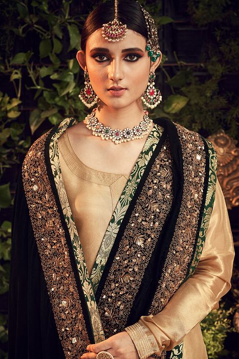 A model showcasing Gold Garara Set With Velvet Dupatta by Ranian from Ranian's collection A model showcasing Gold Garara Set With Velvet Dupatta by Ranian from Ranian's collection