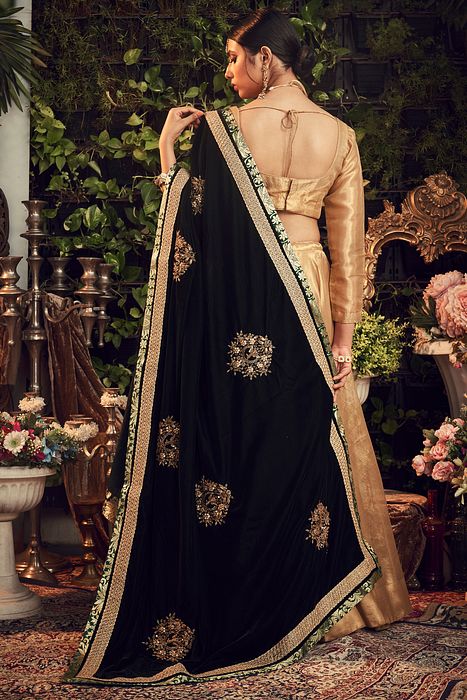 A model showcasing Gold Lehenga With Velvet Dupatta by Ranian from Ranian's collection A model showcasing Gold Lehenga With Velvet Dupatta by Ranian from Ranian's collection