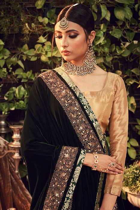 A model showcasing Gold Lehenga by Ranian from Ranian's collection A model showcasing Gold Lehenga by Ranian from Ranian's collection