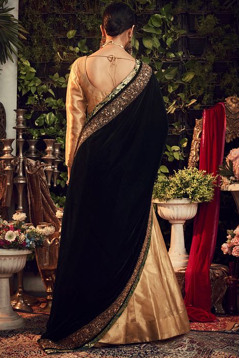 A model showcasing Gold Lehenga by Ranian from Ranian's collection A model showcasing Gold Lehenga by Ranian from Ranian's collection