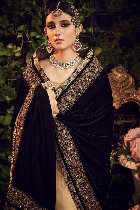 A model showcasing Oxidised Gold Sharara Set by Ranian from Ranian's collection A model showcasing Oxidised Gold Sharara Set by Ranian from Ranian's collection