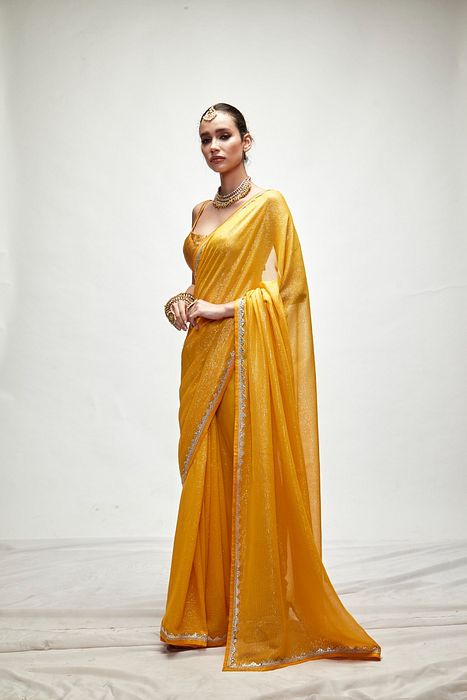 A model showcasing Dandelion Yellow Mettalic Saree Set by Ranian from Ranian's collection A model showcasing Dandelion Yellow Mettalic Saree Set by Ranian from Ranian's collection