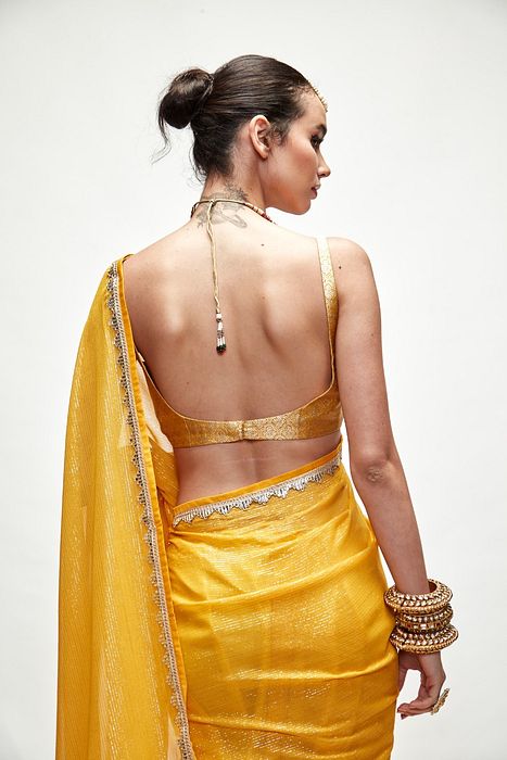 A model showcasing Dandelion Yellow Mettalic Saree Set by Ranian from Ranian's collection A model showcasing Dandelion Yellow Mettalic Saree Set by Ranian from Ranian's collection