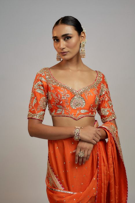 A model showcasing Golconda Orange Fez Saree Set by Gopi Vaid from Gopi Vaid's collection