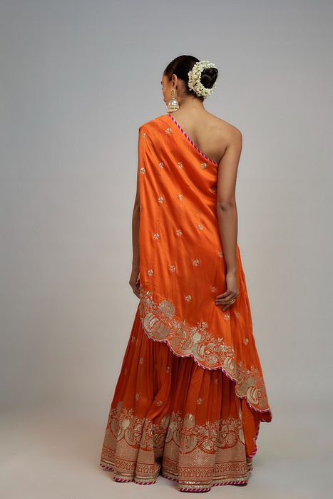 A model showcasing Golconda Orange Aashna Sharara Set by Gopi Vaid from Gopi Vaid's collection