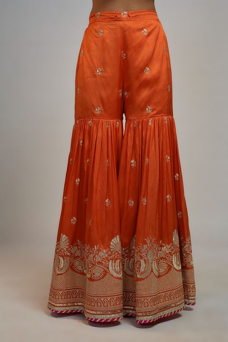 A model showcasing Golconda Orange Aashna Sharara Set by Gopi Vaid from Gopi Vaid's collection