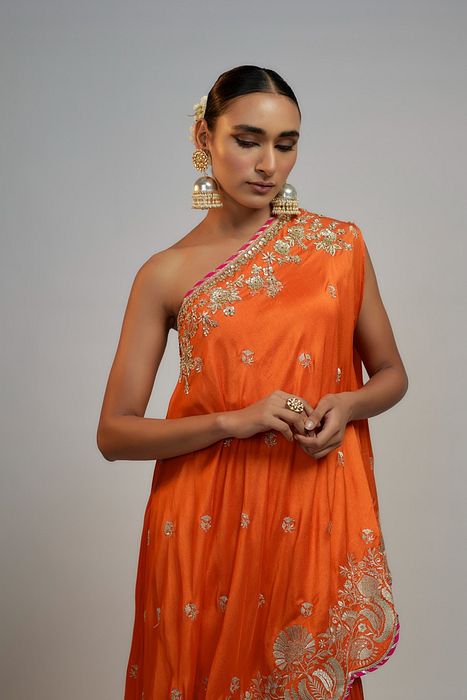 A model showcasing Golconda Orange Aashna Sharara Set by Gopi Vaid from Gopi Vaid's collection