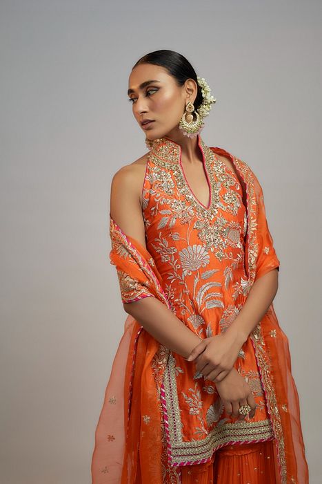 A model showcasing Golconda Orange Sitara Set by Gopi Vaid from Gopi Vaid's collection